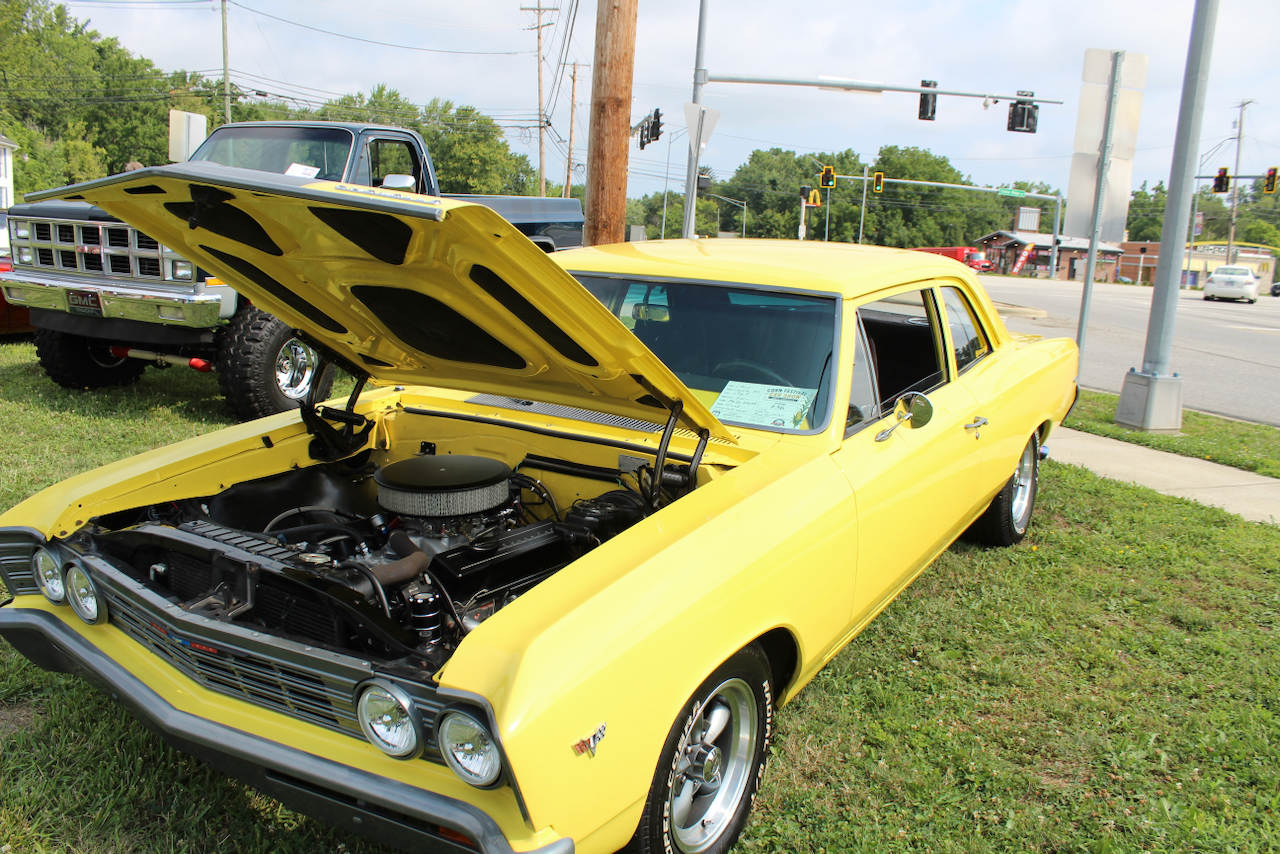 1960s Chevrolet muscle car, yellow, hood open front three-quarter view